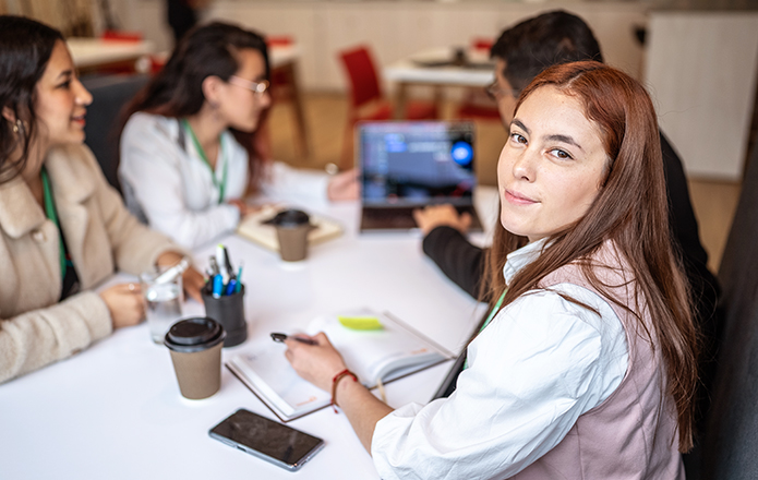 Interns working around a table in a work setting