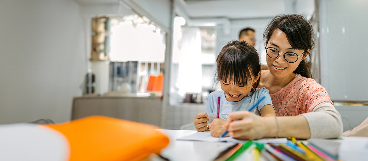 woman and daughter coloring