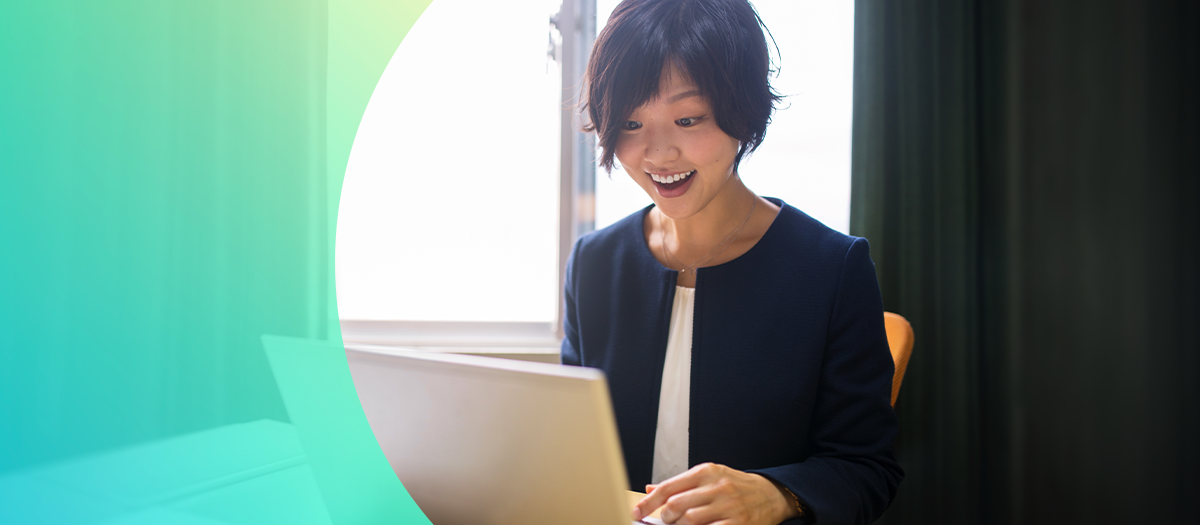 woman smiling looking at computer